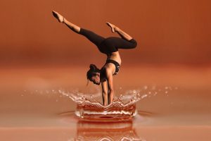 WOMAN PLUNGING INTO WATER IN A DANCE POSE