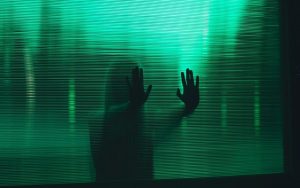 woman behind a glass pane