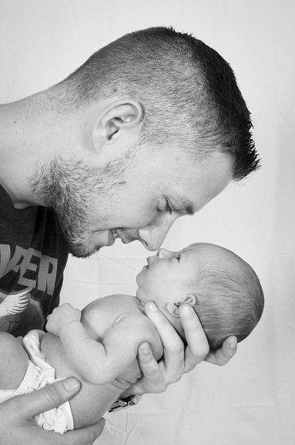 FATHER CARRYING BABY