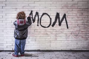 grafitti by little boy that says mom