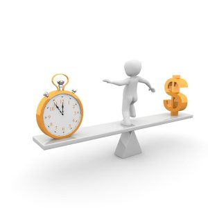 SEE SAW WITH TIME CLOCK ON ONE SIDE AND D0LLAR SIGN ON THE OTHER