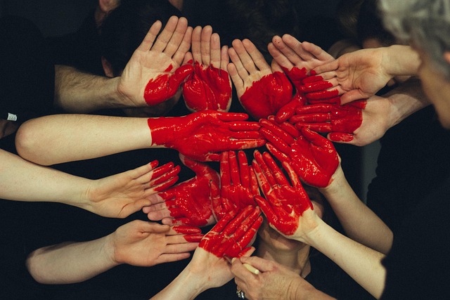a lot of hands and in center a heart in watercolor