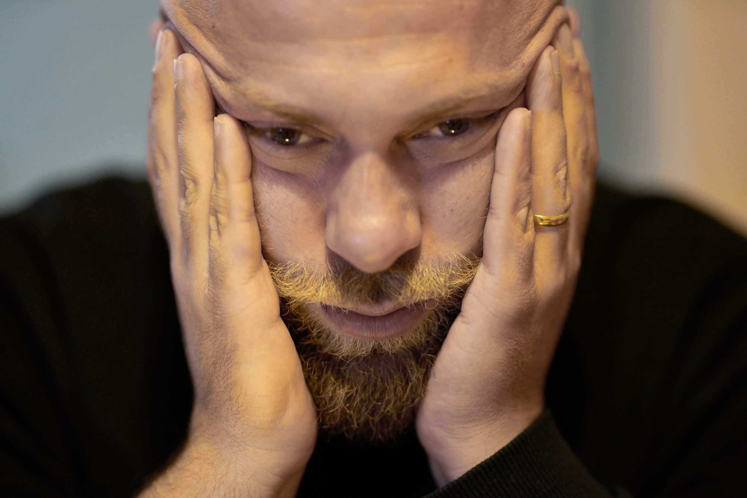 man with head in hands