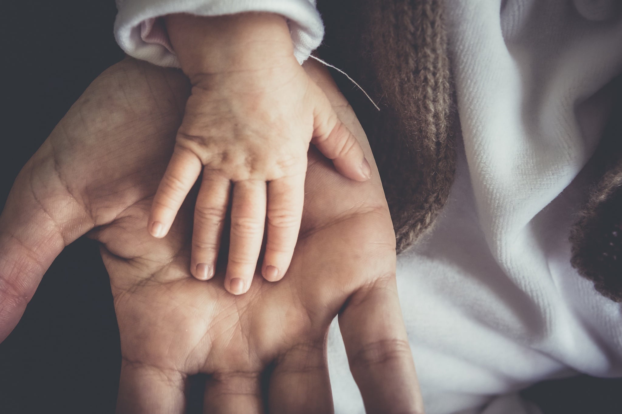 baby hand on dad hand