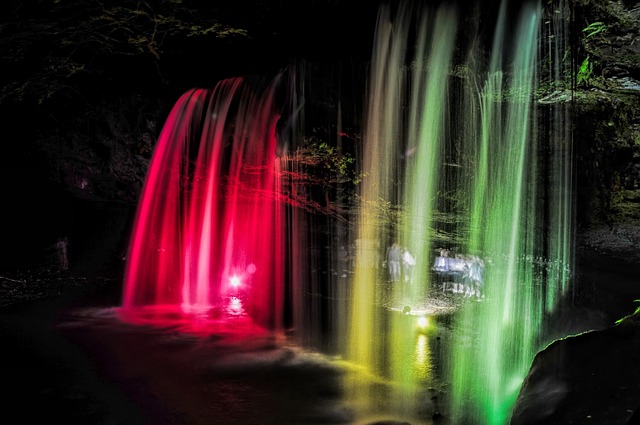 waterfall with lights behind it