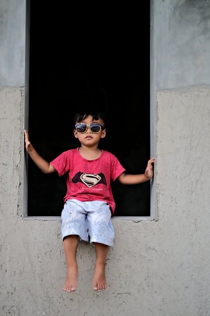 BOY SITTING ON WALL CONFIDENT