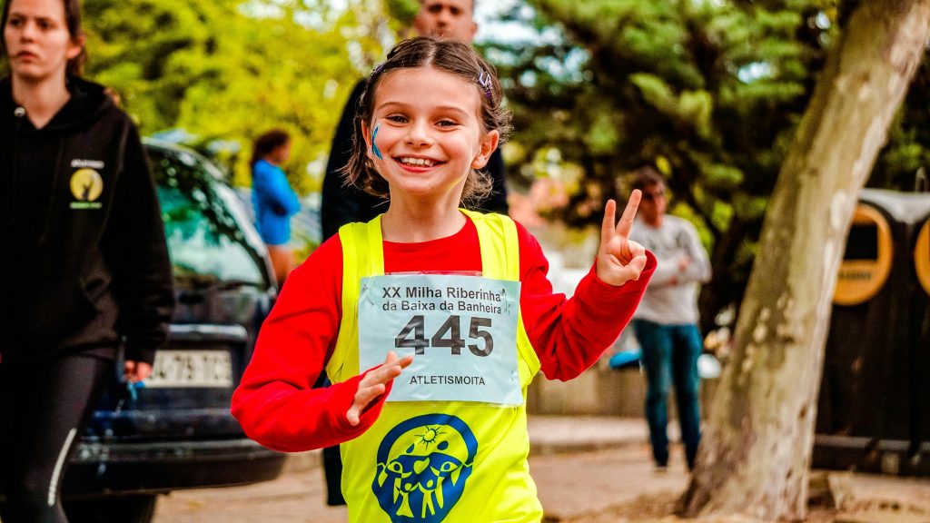Girl running across finish line