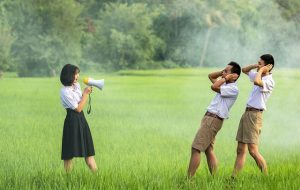 KIDS PLAYING TEACHER WITH A MEGAPHONE