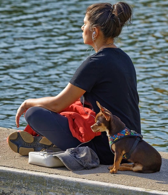 WOMAN SITTING ON A PIER