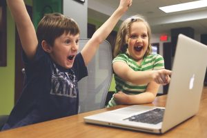 KIDS PLAYING WITH COMPUTER
